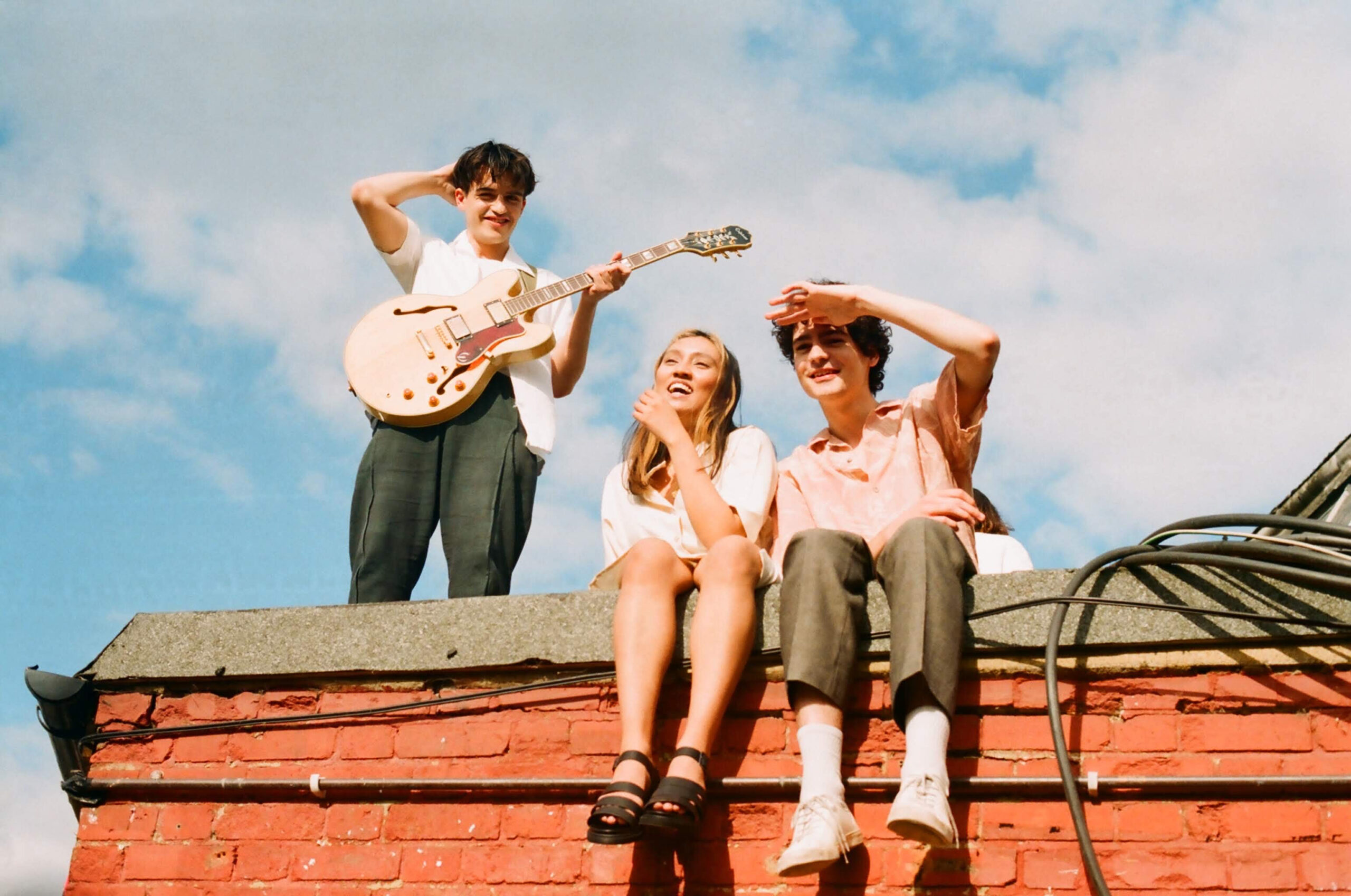 Pastel singing on a roof with guitar