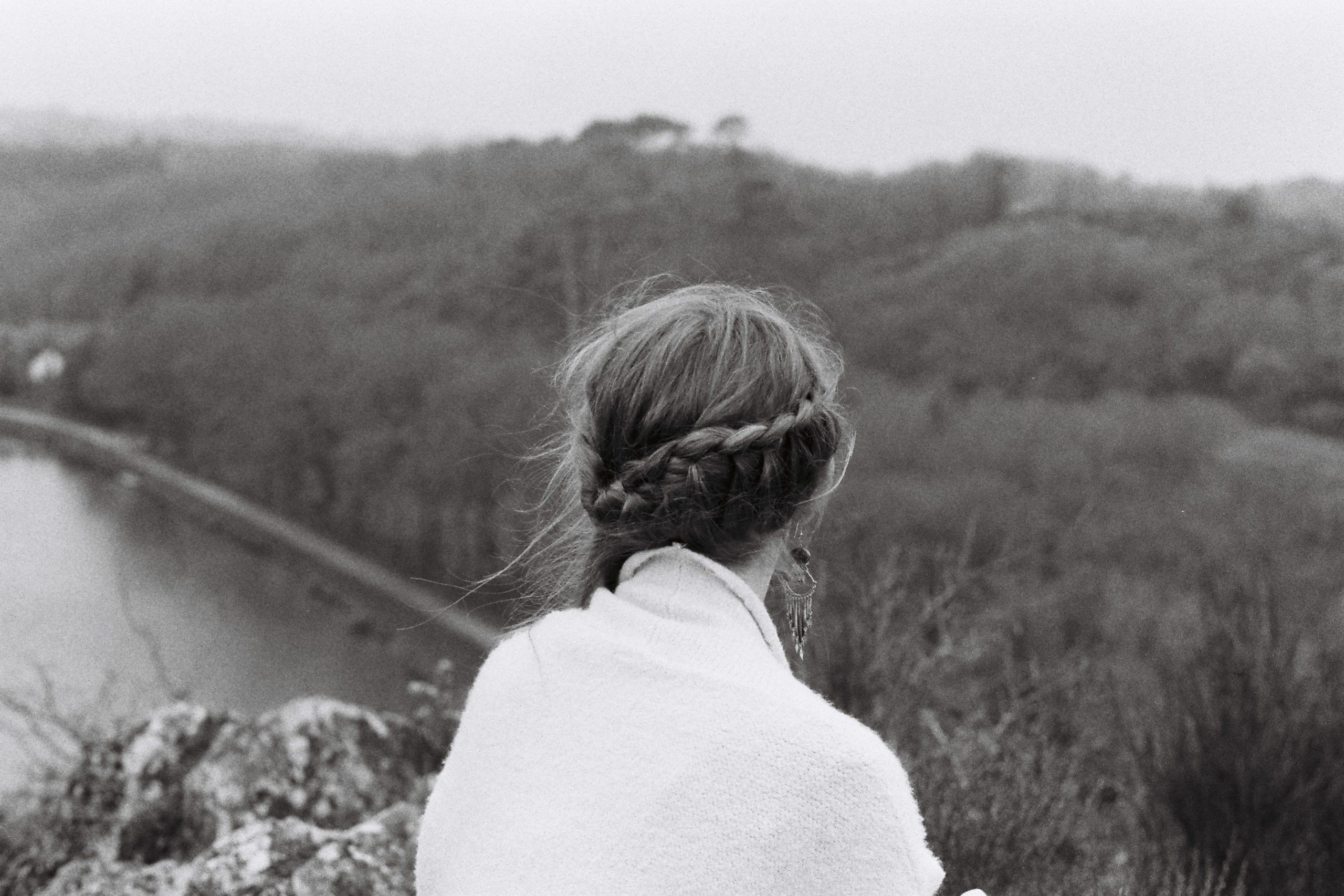 Black and white portrait girl with braided hair from the back